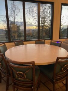 Finished limestone table with a smooth satin finish, surrounded by chairs and ready for use, showcasing its elegant design and durable AntiEtch® protection.