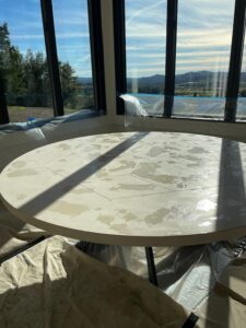 Angled view of the limestone table showing resin-filled holes with UV-resistant adhesive, highlighting the restoration process.